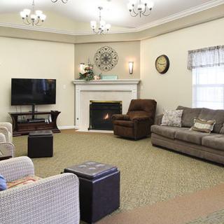 A cozy living room with comfortable seating and a fireplace.