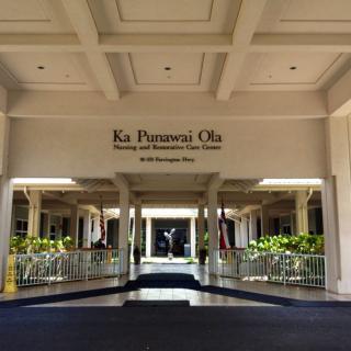 Main entrance of a resort with columns and welcoming architecture.