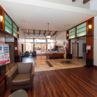 A spacious and modern lobby with a reception desk and seating area.