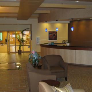 A modern lobby with a reception desk and comfortable seating.