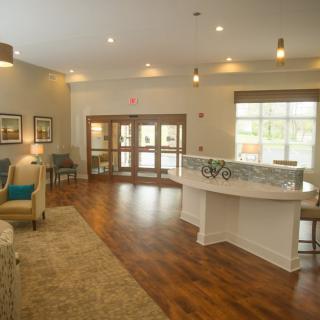 A welcoming lobby with a reception desk, comfortable seating, and modern decor.