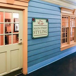 The entrance of a shop named 'Main Street Styling' with a blue exterior and beige accents.