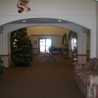 A cozy lobby decorated for the holidays with a Christmas tree and comfortable seating.