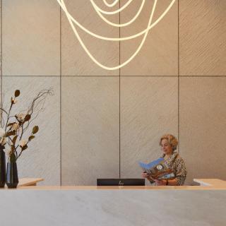 A modern reception area with elegant lighting and floral arrangements.