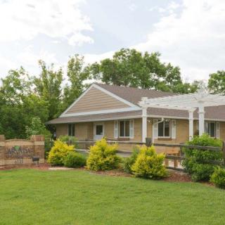 A charming house with a well-maintained lawn and lush garden.