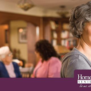 Elderly people socializing in a cozy nursing home environment.