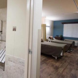 A clean and modern healthcare room with multiple beds.