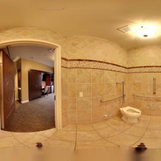 A spacious and modern bathroom featuring tiled walls and floor.