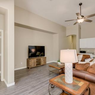 A modern living room with a cozy sofa, large TV, and stylish decor.