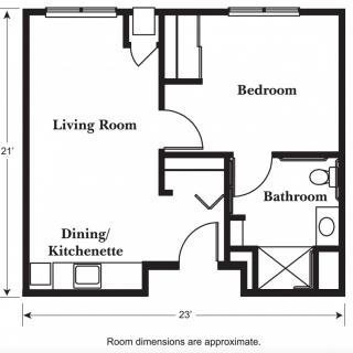 A floor plan depicting a one-bedroom apartment layout, featuring a living room, dining/kitchenette area, and a bathroom.