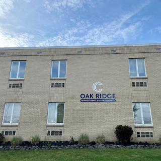 The exterior view of the Oak Ridge building with clear skies above.