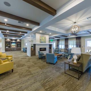 A spacious and modern lounge area with comfortable seating and stylish lighting fixtures.
