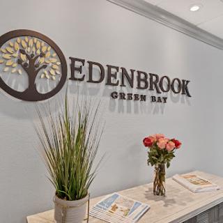 The welcoming reception area of Edenbrook in Green Bay, featuring modern decor and floral arrangements.