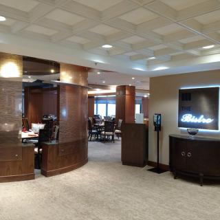 A modern dining area with elegant wood finishes and comfortable seating.