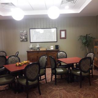 A cozy dining area featuring round tables and comfortable chairs, adorned with decorative elements.
