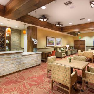 A modern hotel lobby with a reception desk and comfortable seating area.