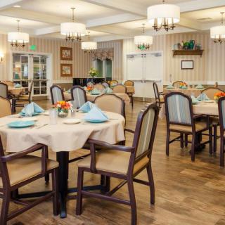 An elegantly designed dining room with neatly arranged tables and chairs.