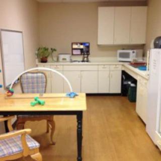 A small office kitchen area with a coffee maker, microwave, and refrigerator.