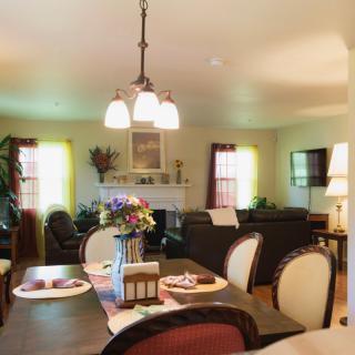 A cozy living and dining area with warm lighting and tasteful decor.