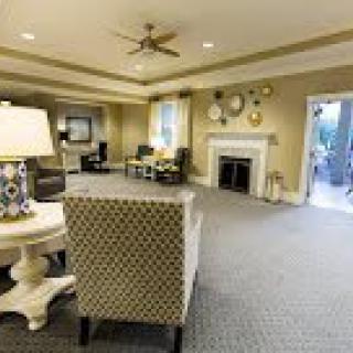 A cozy living room featuring comfortable seating, a fireplace, and elegant decor.
