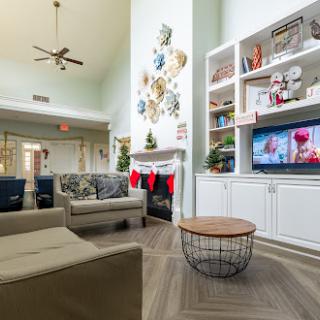 A cozy and modern living room featuring comfortable seating, a stylish coffee table, and festive holiday decorations.