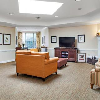 A bright and cozy living room with comfortable sofas, a television, and elegant decor.