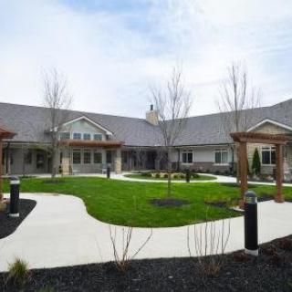 A courtyard with a central landscaped garden and pathways around a modern building.
