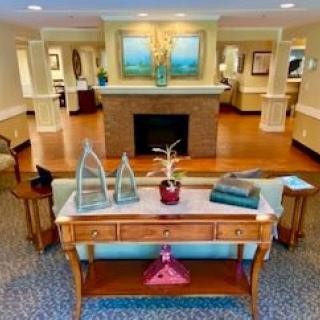 A beautifully decorated living room featuring a central fireplace and elegant furnishings.