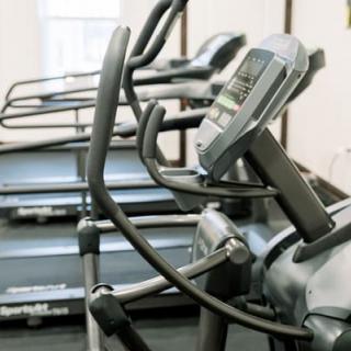 A row of treadmills in a gym, ready for a workout session.