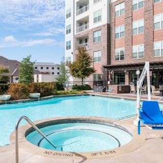 Outdoor pool and hot tub area at an apartment complex.