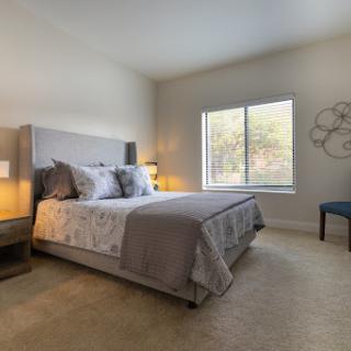 A cozy and modern bedroom showcasing a comfortable bed with stylish decor.