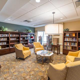 A cozy library reading area with chairs and bookshelves.