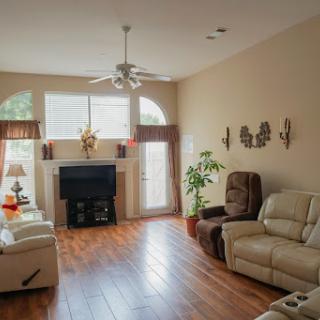 A cozy living room featuring comfortable seating, natural light streaming in, and a warm atmosphere.