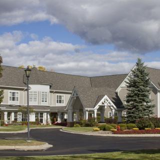 A spacious residential building under a cloudy sky.