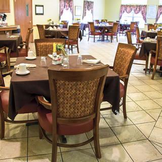 A cozy dining area with neatly arranged tables and chairs.