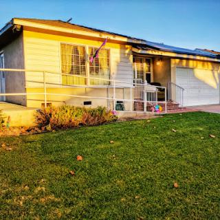 A charming residential home basking in the warm glow of sunset.