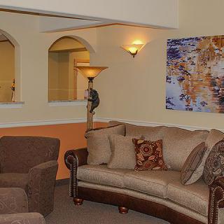 A cozy living room featuring comfortable seating and decorative artwork.