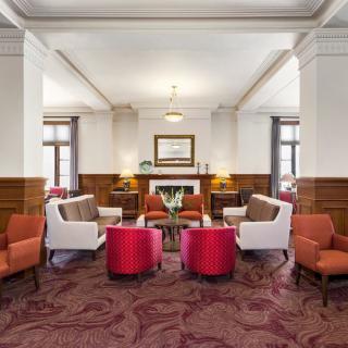 A stylish hotel lobby with comfortable seating and elegant decor.
