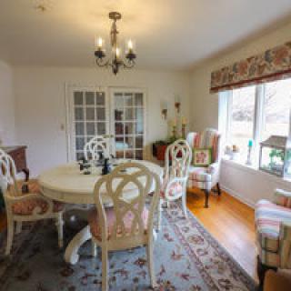 A cozy dining room with vintage furniture and a welcoming atmosphere.