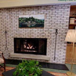 Cozy living room with a brick fireplace and decorative elements.