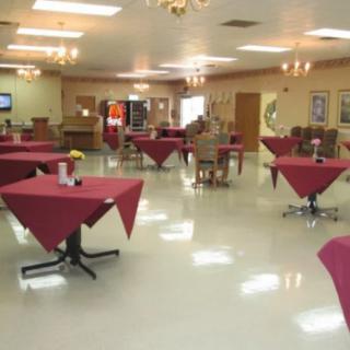 A spacious dining area with tables and chairs arranged neatly.