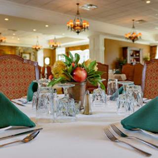 An elegant dining setup featuring a beautifully arranged table with floral centerpiece and stylish decor.