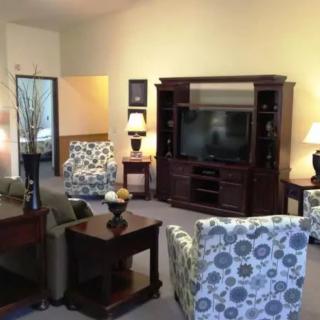 A cozy living room with comfortable seating and a large entertainment center.
