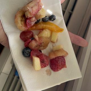 A small serving of assorted fruit on a plate.