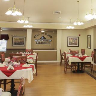 An empty dining area with neatly arranged tables and chairs, featuring elegant decor.