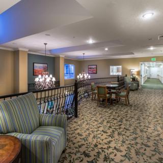 A cozy interior space featuring comfortable seating and elegant lighting.