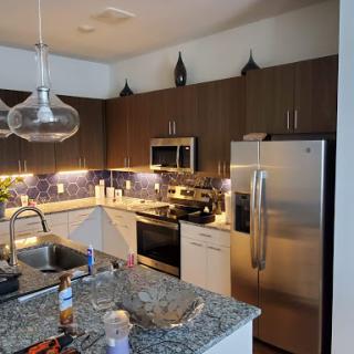 A modern kitchen showcasing sleek appliances and beautiful granite countertops.