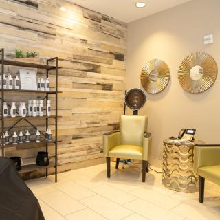 A cozy salon waiting area with stylish decor and comfortable seating.