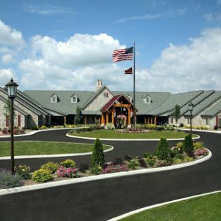 A picturesque view of a modern building with landscaped gardens and an American flag flying.
