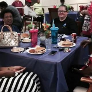 A group of people enjoying a meal together at a table indoors.